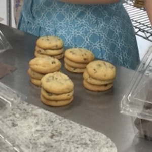 Chocolate chip cookies are stacked, waiting to be put into a container