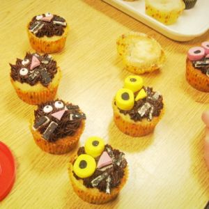 Several cupcakes are decorated to look like cat faces