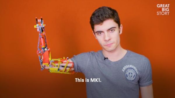 teenage boy with mechanical arm built of Lego
