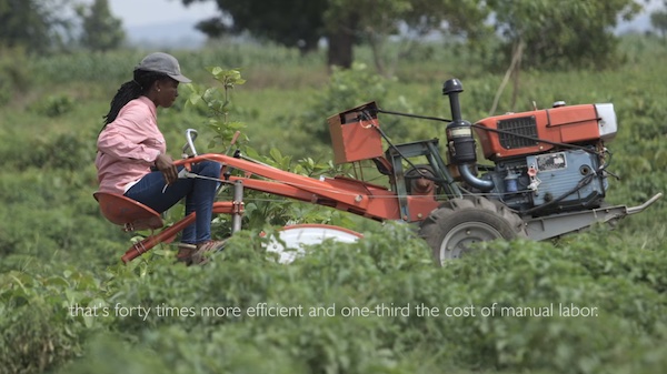 woman driving a tractor in a green field