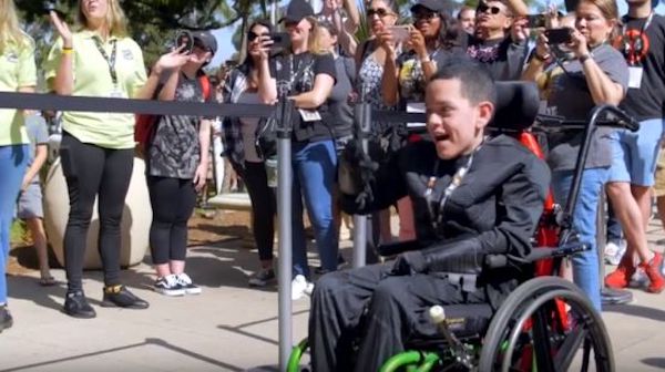 boy in wheelchair cheering