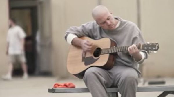 outdoor prison yard with prisoners relaxing