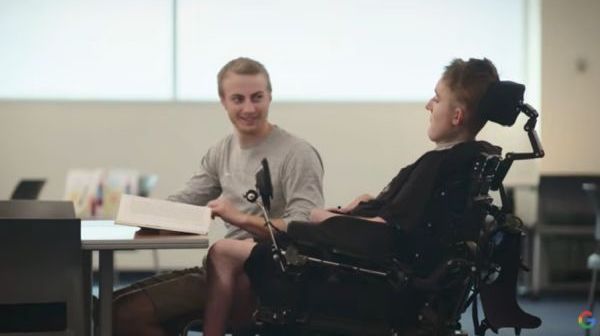 A boy in a wheelchair in a colorful bedroom