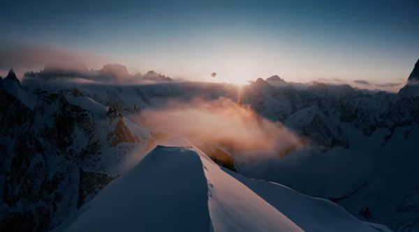 man on skis going down a steep hill