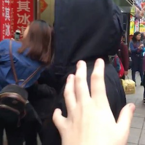 A hand reaching out to someone in a crowd