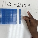 Blue number tiles show a subtraction problem